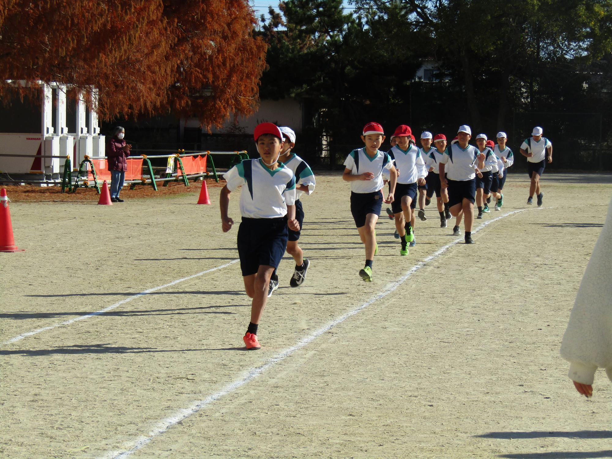 グラウンドを周回する高学年男子たち